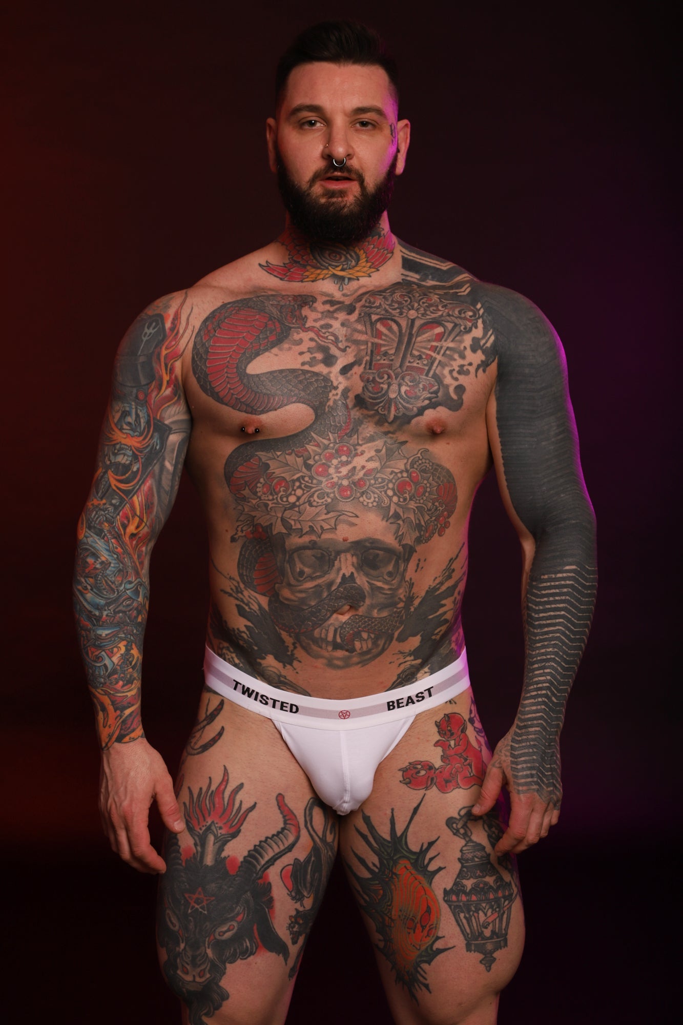 A model looking into the camera wearing a white Insignia Jock by Twisted Beast.