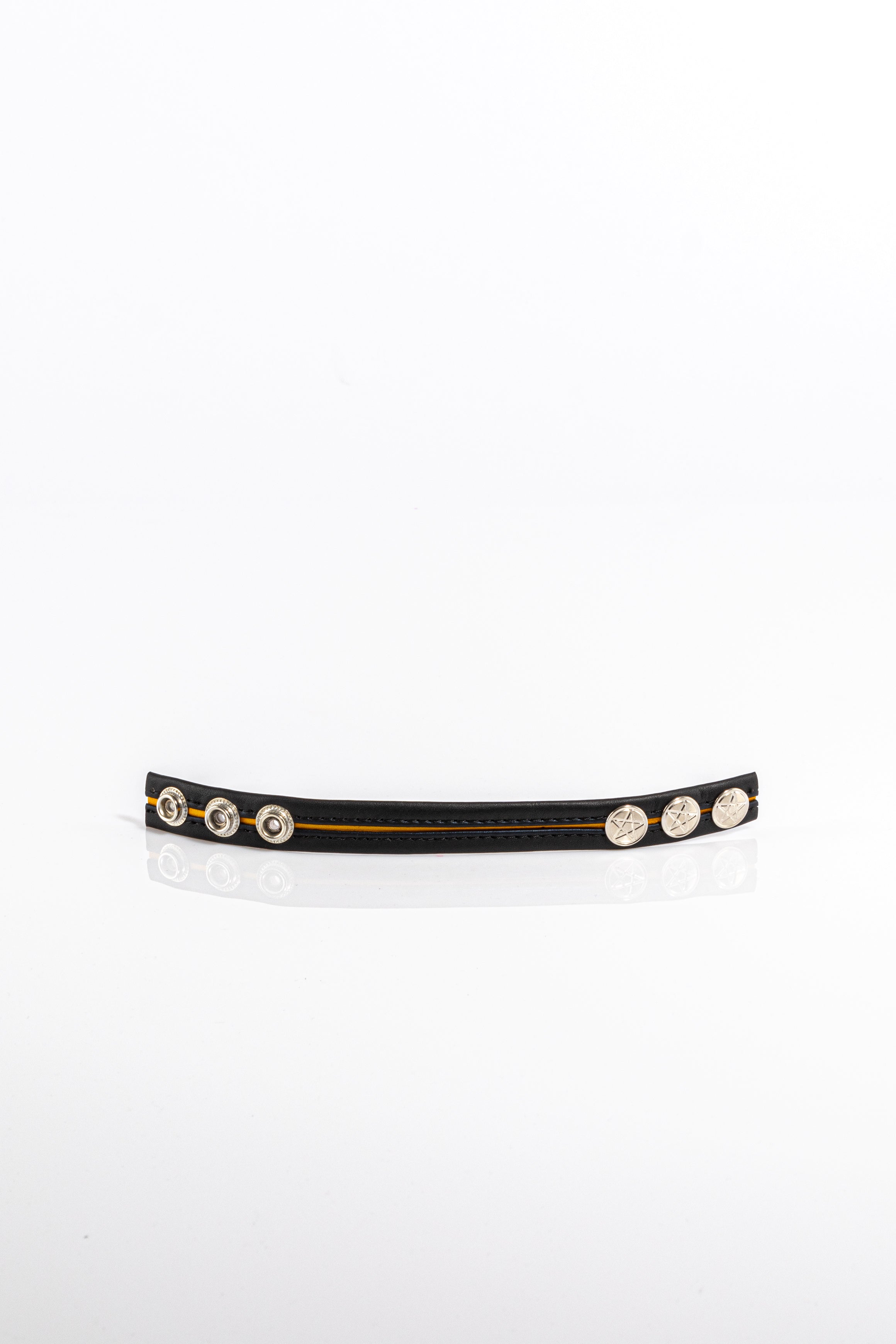 A product photo of a black leather cock ring with yellow trim.
