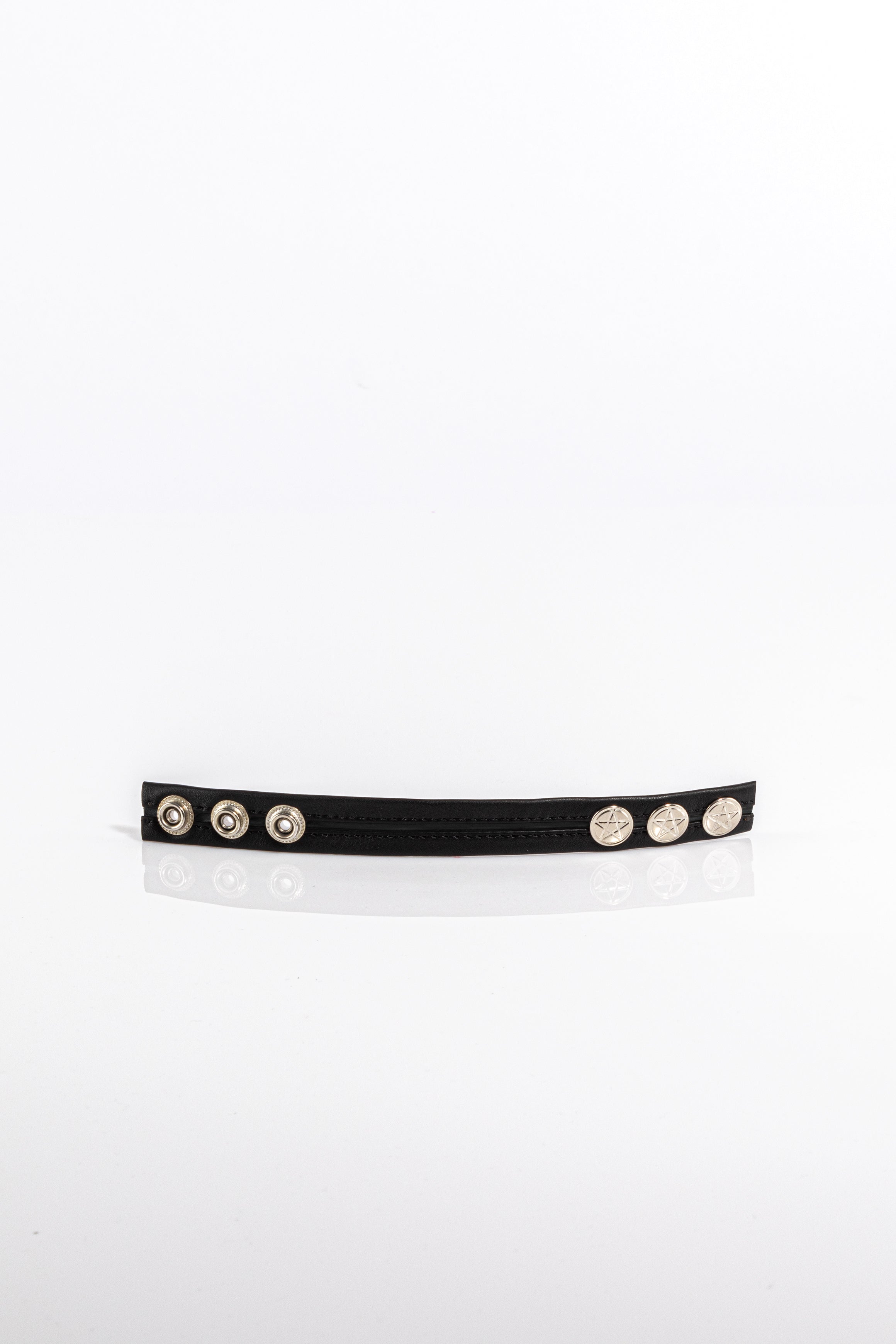 A product photo of a black trimmed black cock ring.