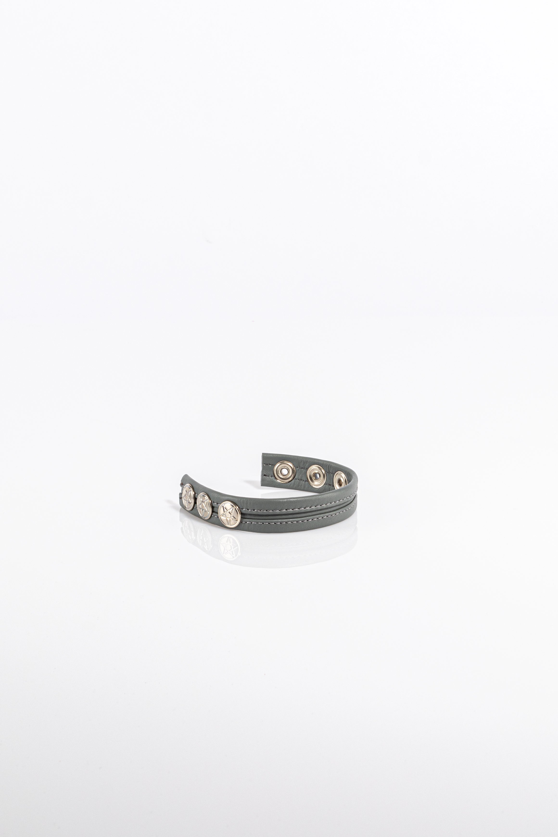 A product photo of a solid grey cock ring.