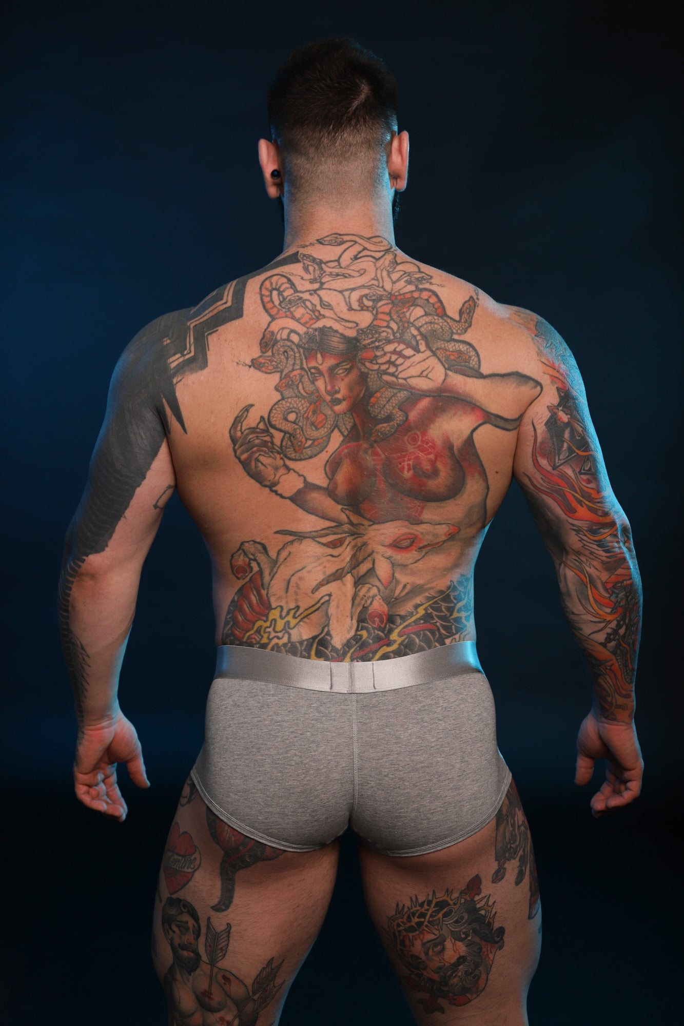 A model for Twisted Beast with his body facing away from the camera wearing Phantom Boxers in Grey.