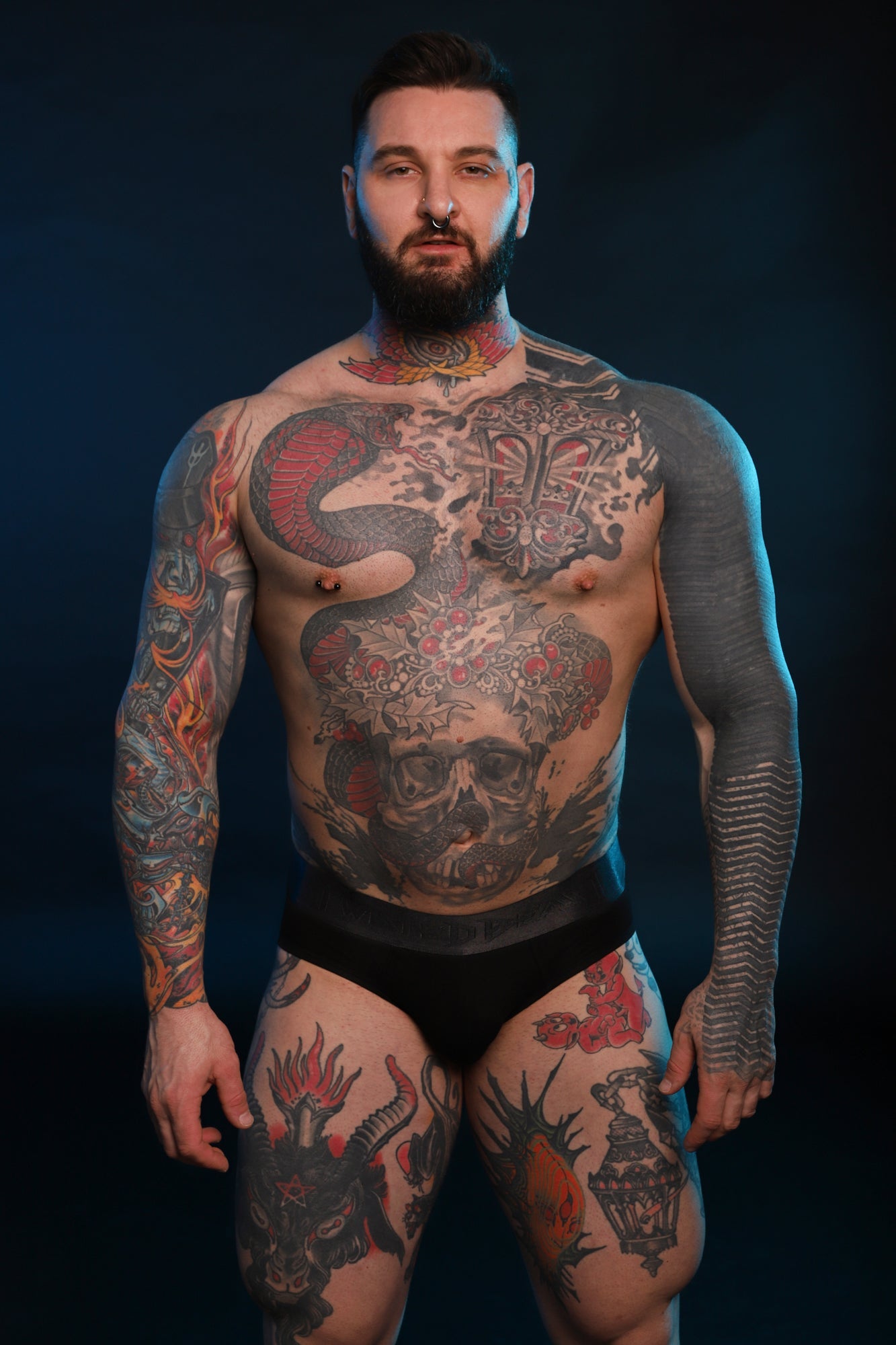 A frontal photo of a model wearing a pair of black Phantom Briefs by Twisted Beast.