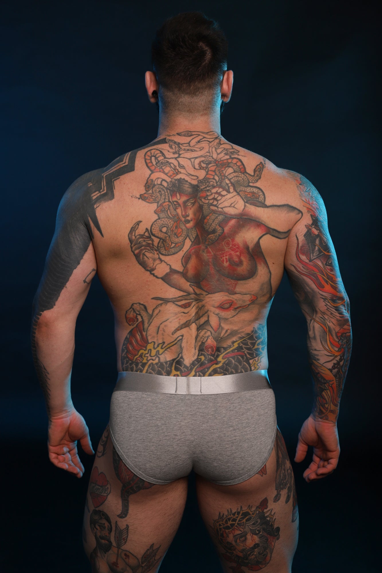 A photo taken of the back of a model wearing Grey Twisted Beast Phantom Briefs.