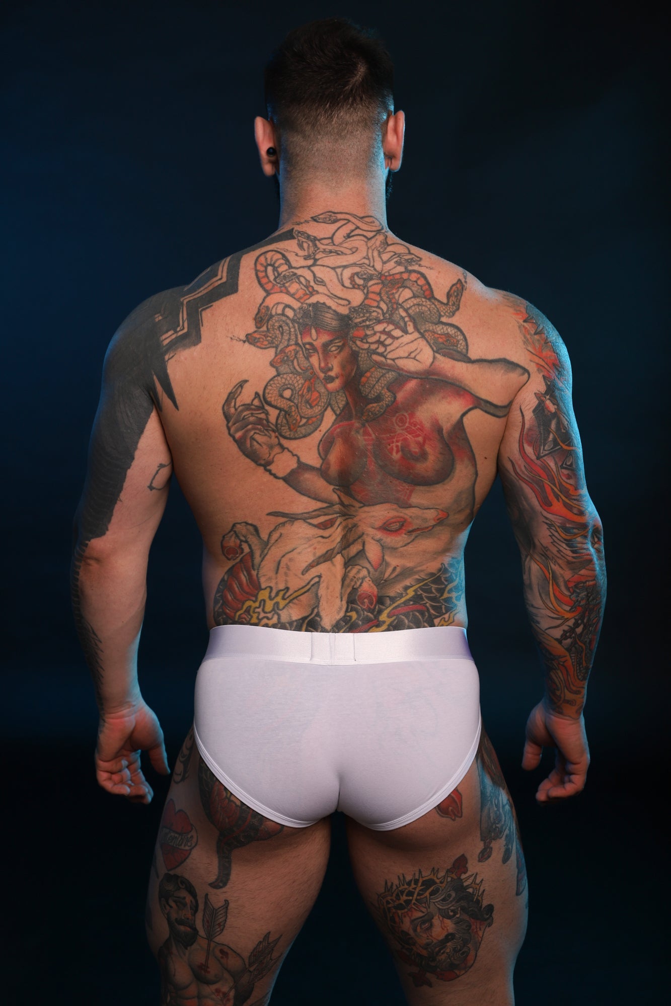 A back shot of a model wearing Phantom Briefs in white.