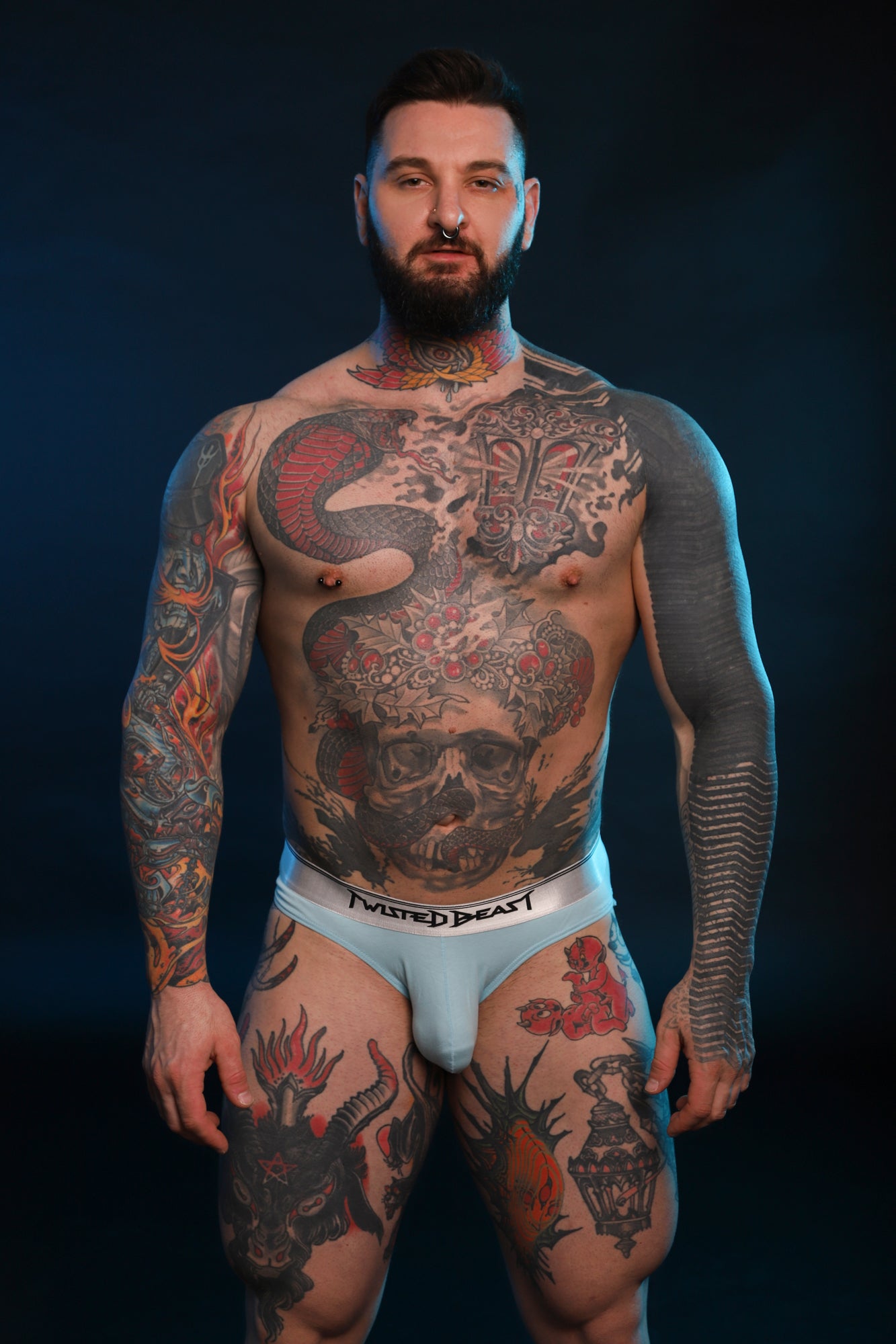 A front facing photo of a model wearing Y2K Briefs in blue by Twisted Beast.