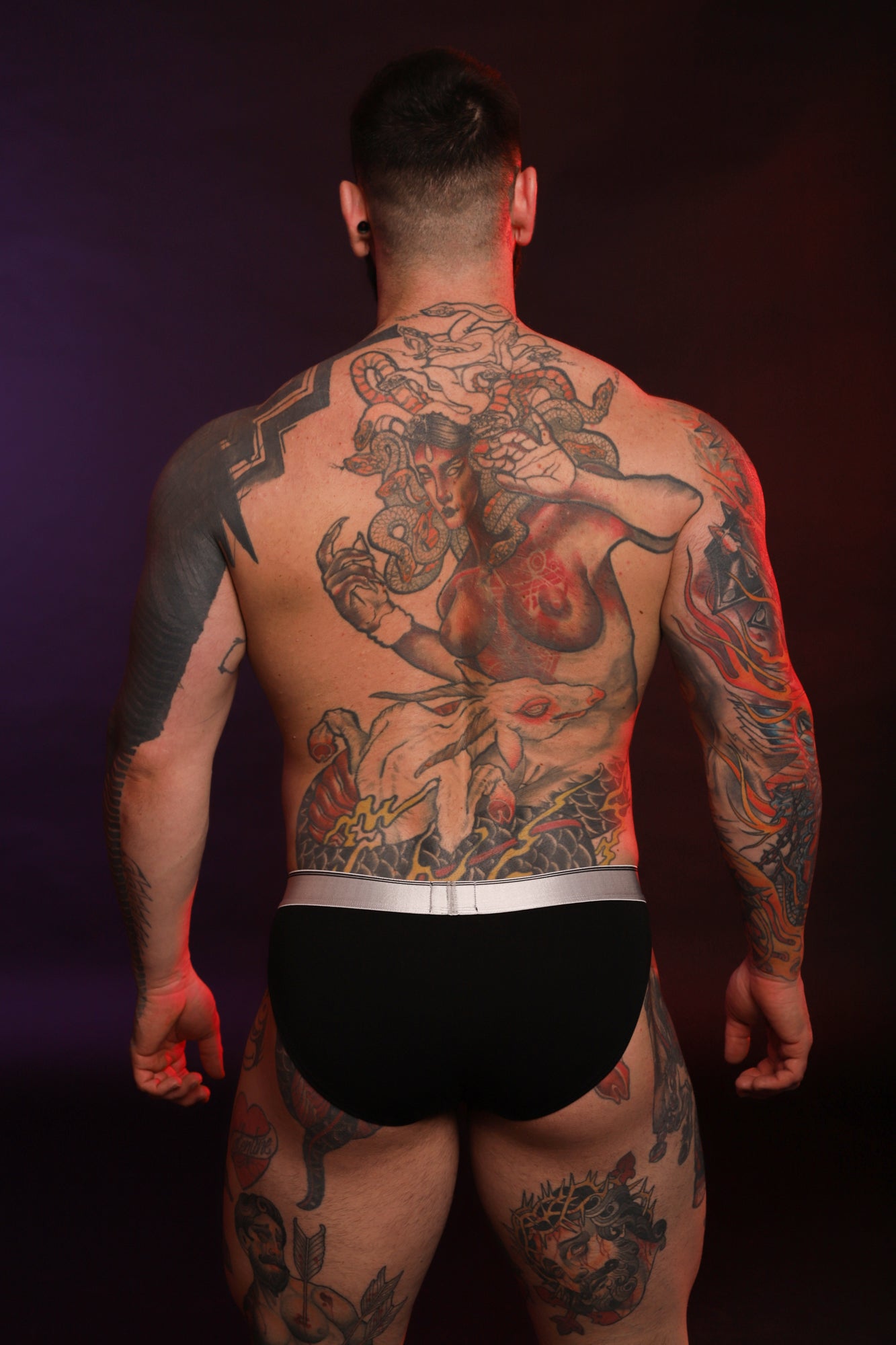 A model wearing a pair of black Y2K Briefs taken from the back.